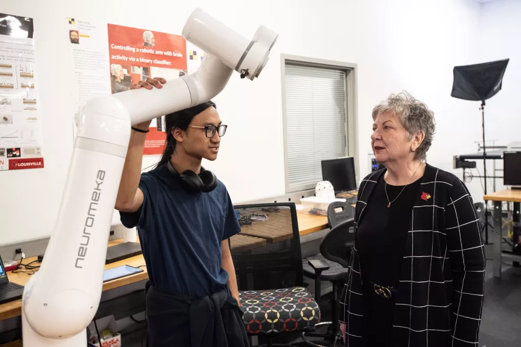 Two people discussing robotic device