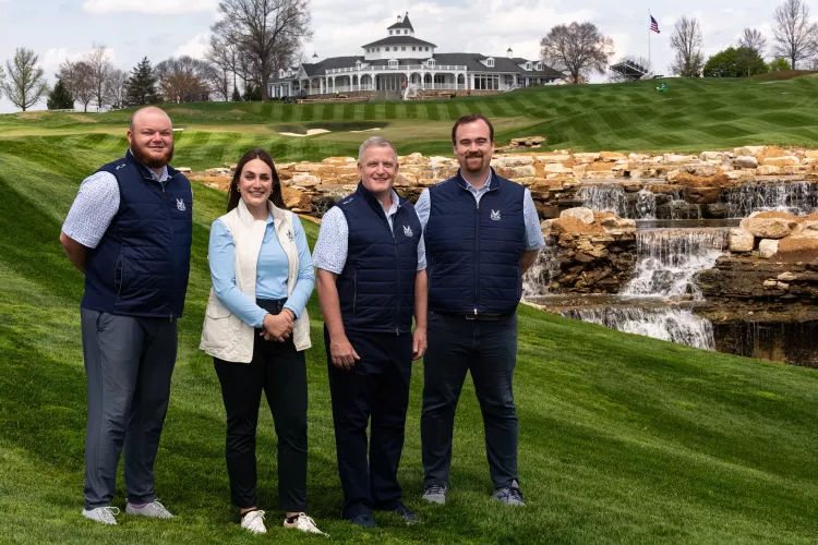 3 men and a woman on a golf course