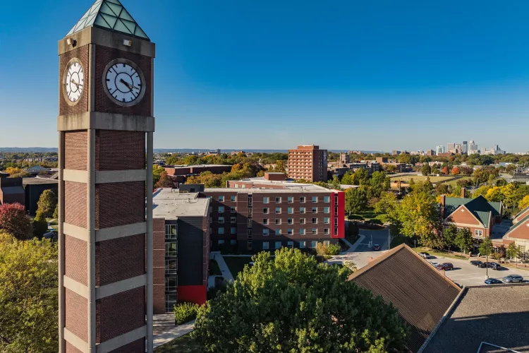 High angle shot of the Student Activities Center clock tower with downtown Louisville in the distance