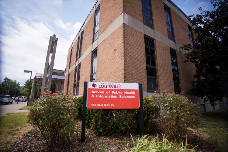 red and white sign in front of building that says University of Louisville School of Public Health and Information Sciences, 485 E. Gray St.