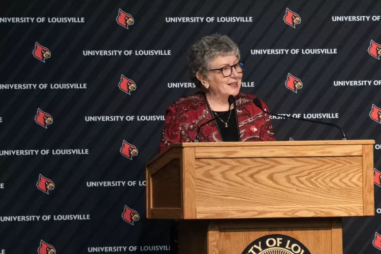 President Schatzel talks with an audience while standing at the podium.