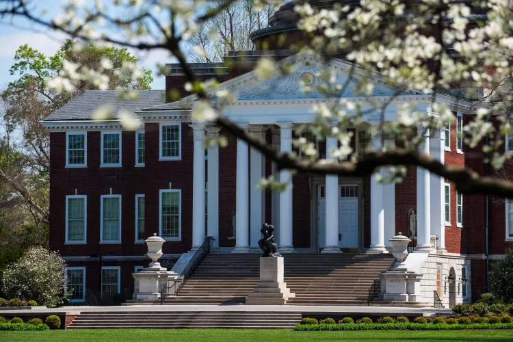 Exterior of Grawemeyer Hall with spring trees in bloom