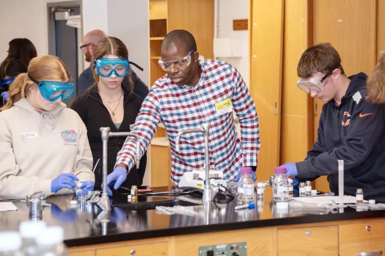 Students work with beakers in a science lab