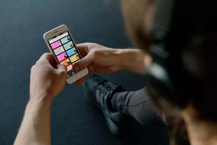Person listens to music on a smartphone.