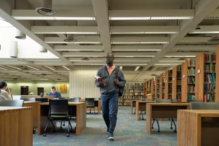 Student walks into the library.