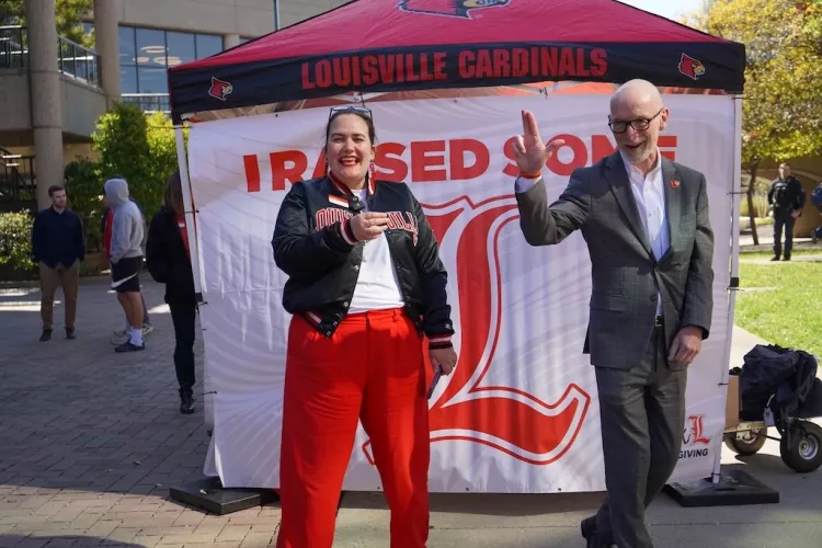 President Bradley throws an L while Amanda James laughs