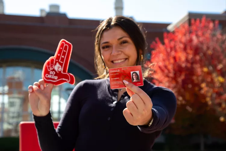 Student holding a Cardinal Card