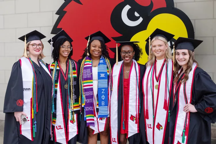 A group of women in commencement caps and gowns.
