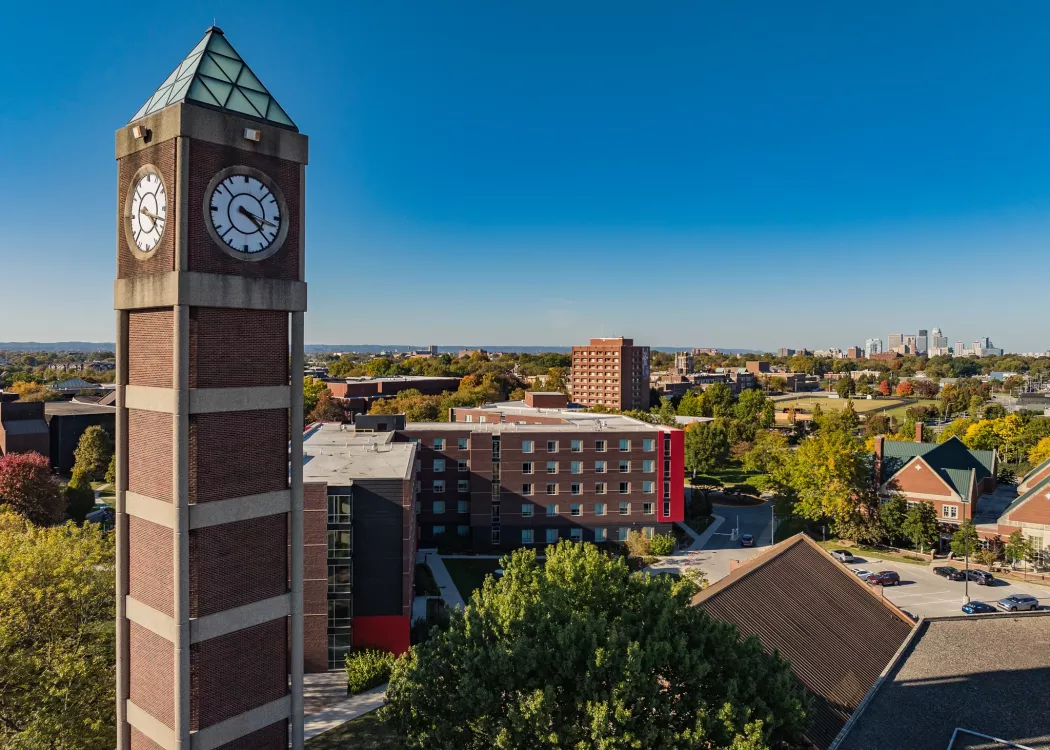 High angle shot of the Student Activities Center clock tower with downtown Louisville in the distance