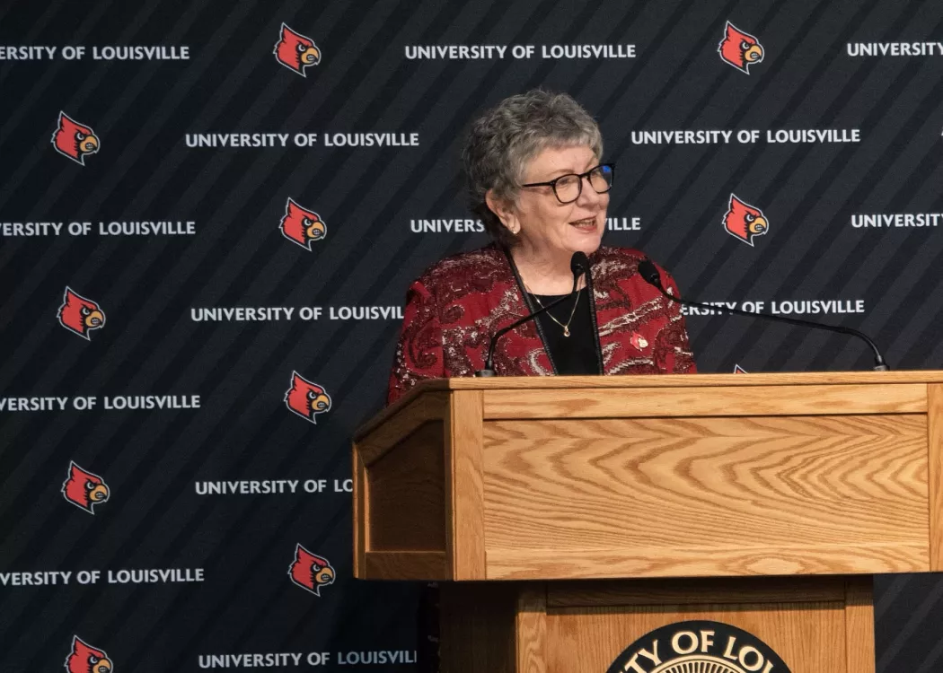 President Schatzel talks with an audience while standing at the podium.