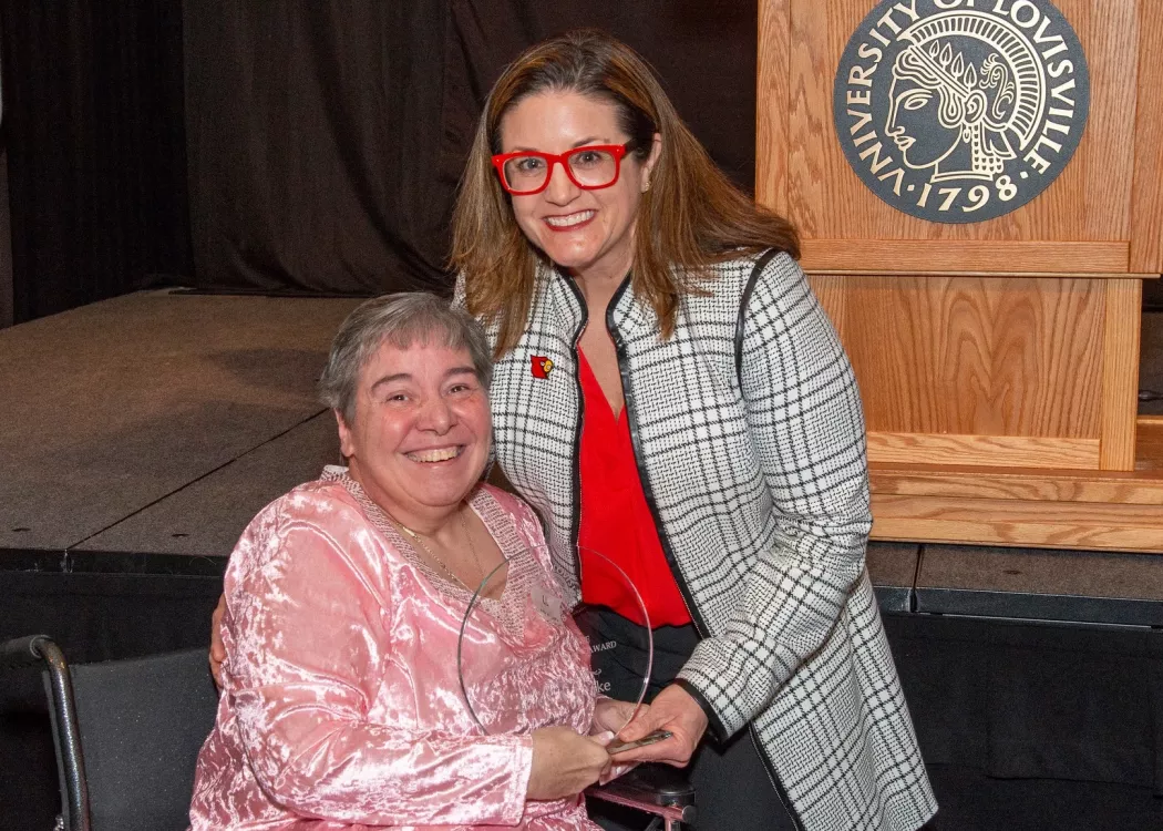 Linda Leake, left, receives the George J. Howe Distinguished Staff Award from University of Louisville Interim Provost Katie Cardarelli at UofL's 2025 Presidential Excellence Awards reception on April 17, 2025.