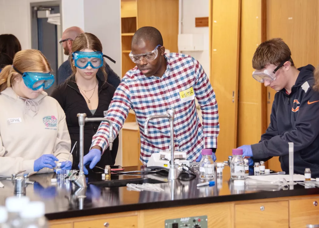 Students work with beakers in a science lab