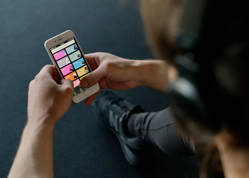 Person listens to music on a smartphone.