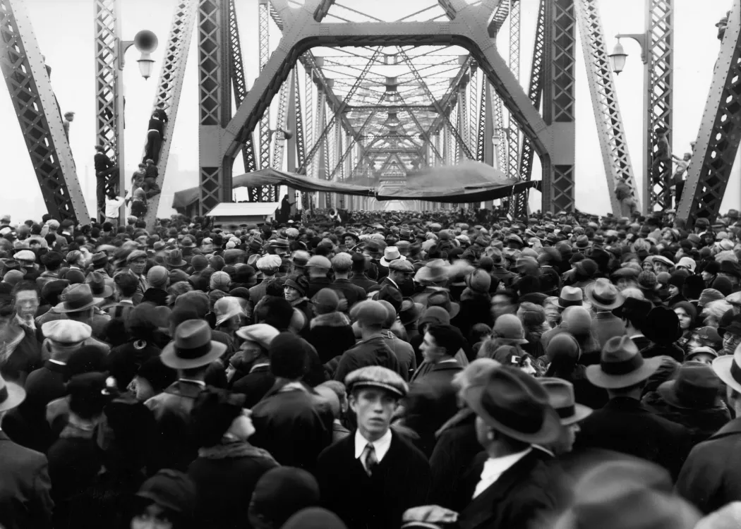 A black and white image of a large crowd gathered on the Indiana side of the Municipal Bridge in 1929.