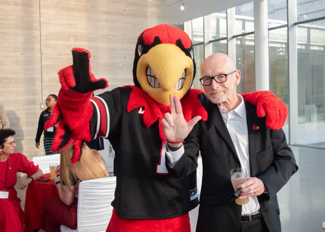 Louie the Cardinal poses with President Bradley