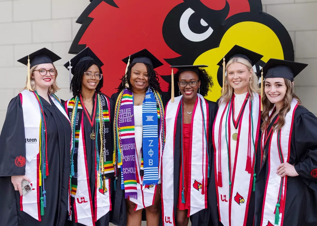 A group of women in commencement caps and gowns.