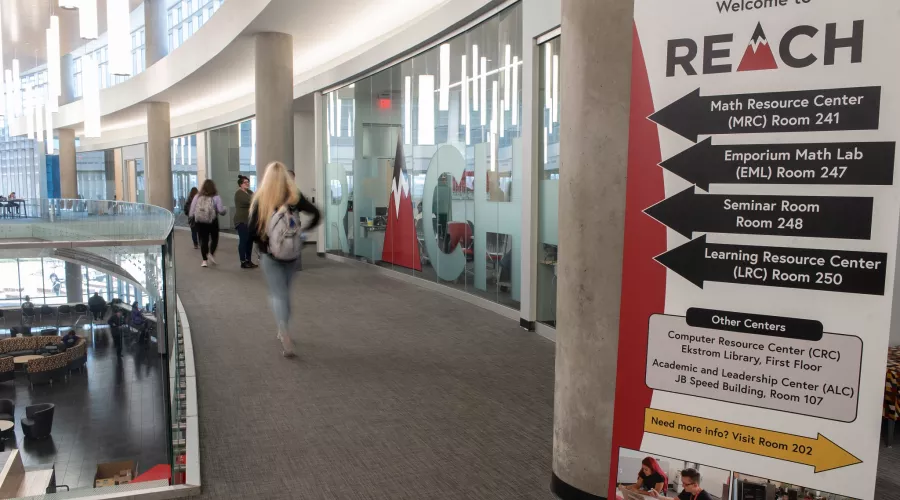 Students walking down the hallway near the REACH offices in the Belknap Academic Building