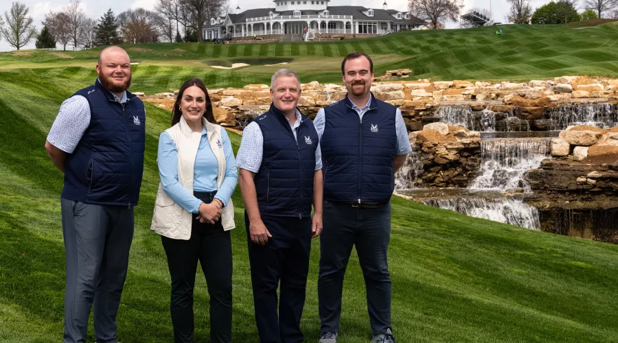 3 men and a woman on a golf course
