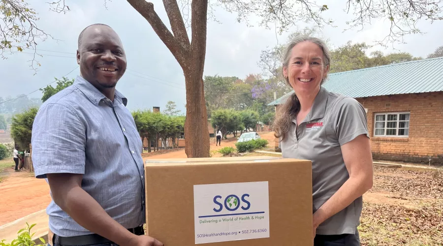 Man and woman holding a box of medical and research supplies in Malawi