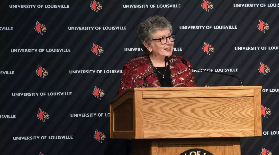 President Schatzel talks with an audience while standing at the podium.