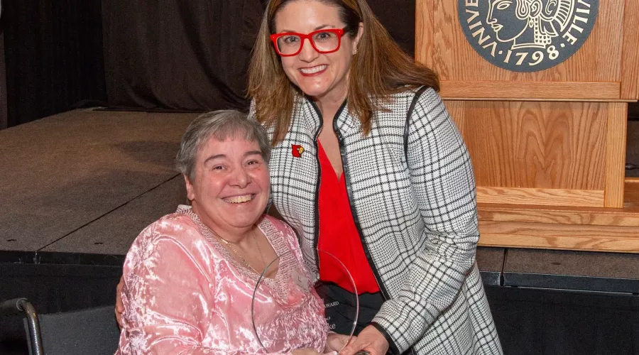 Linda Leake, left, receives the George J. Howe Distinguished Staff Award from University of Louisville Interim Provost Katie Cardarelli at UofL's 2025 Presidential Excellence Awards reception on April 17, 2025.