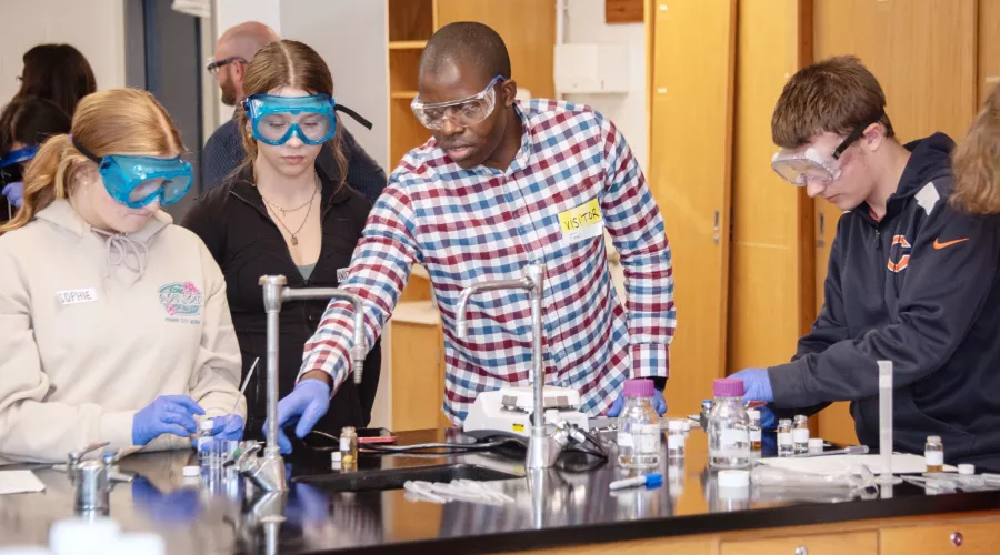 Students work with beakers in a science lab