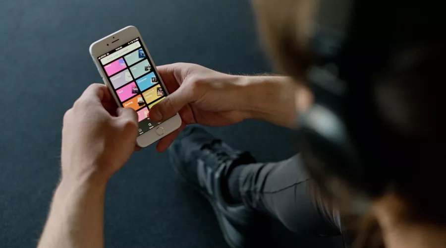 Person listens to music on a smartphone.