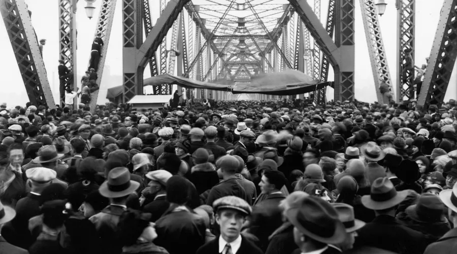 A black and white image of a large crowd gathered on the Indiana side of the Municipal Bridge in 1929.