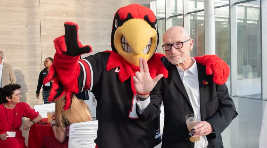 Louie the Cardinal poses with President Bradley