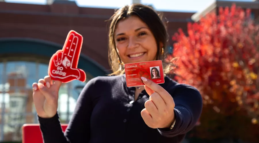 Student holding a Cardinal Card