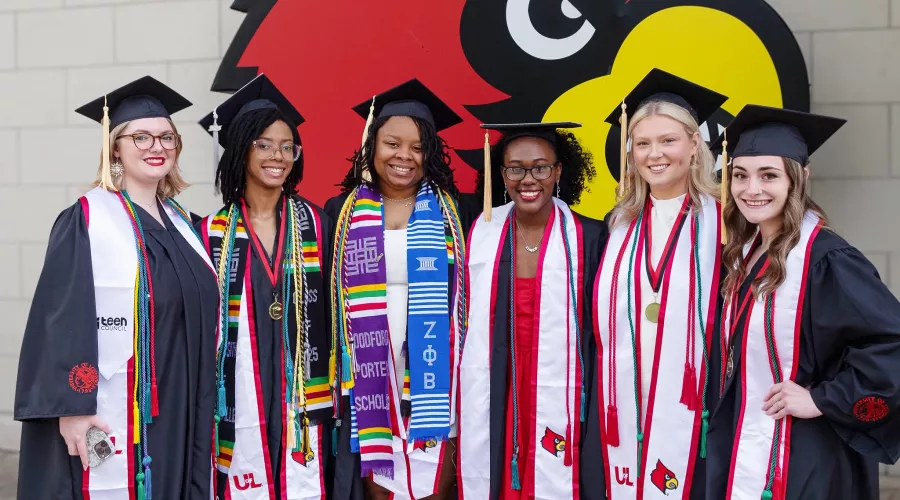 A group of women in commencement caps and gowns.