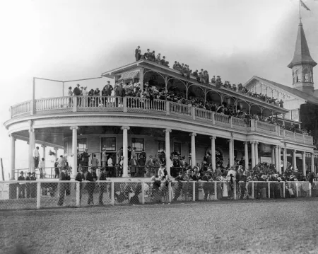 Black and white photograph from 1914 of the old Churchill Downs Clubhouse next to the Twin Spires.