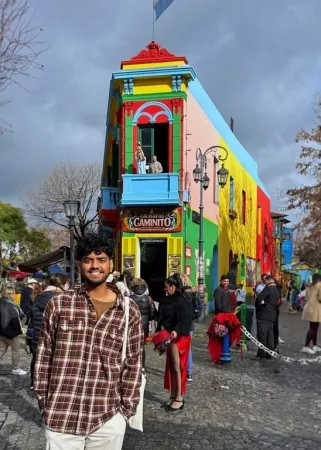 Young man in front of colorful building