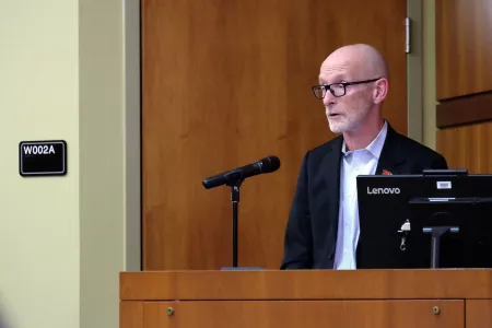 Man speaking at a podium.