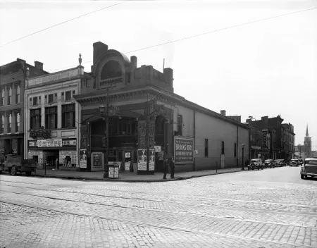A black and white photograph of a street scene of the corner of Market Street and 2nd Street in downtown Louisville in 1938.