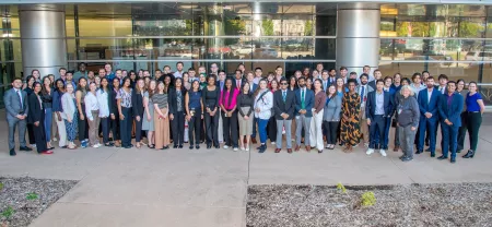 Large group of college students in front of glass building